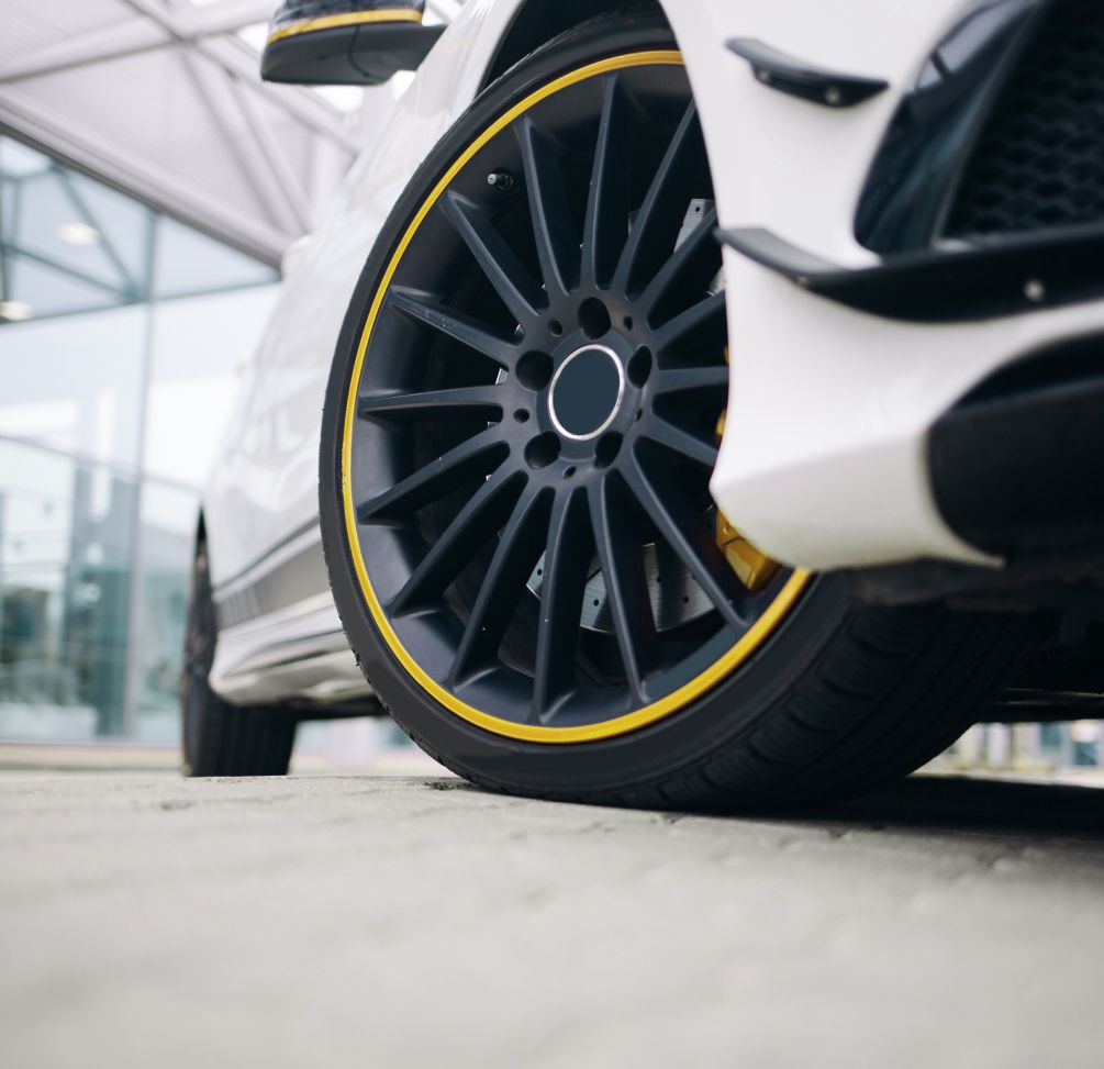The rim of a white car with yellow highlights